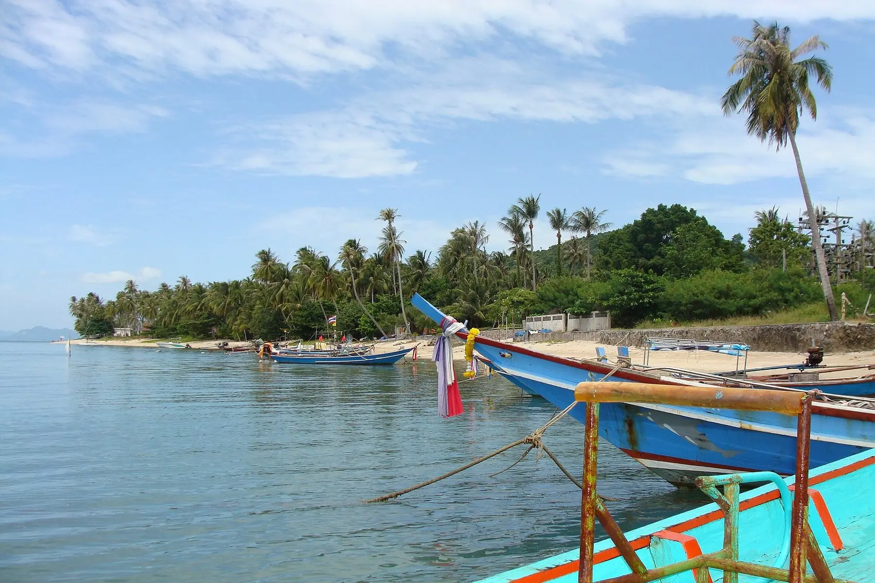 Boats moored off a palm-fringed beach on Koh Samui, Thailand